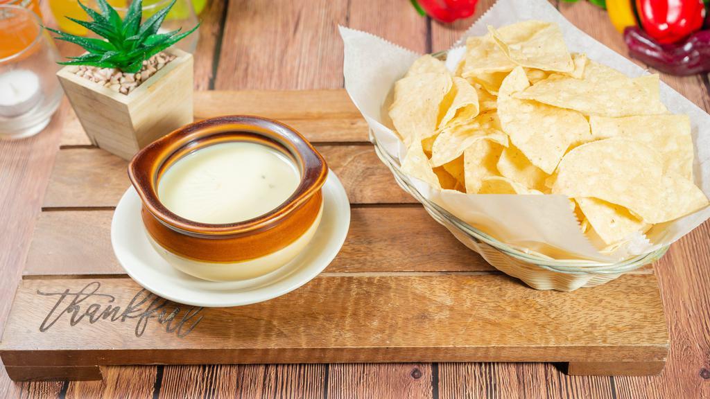 Queso Blanco · Spicy white cheese dip. Served with chips.