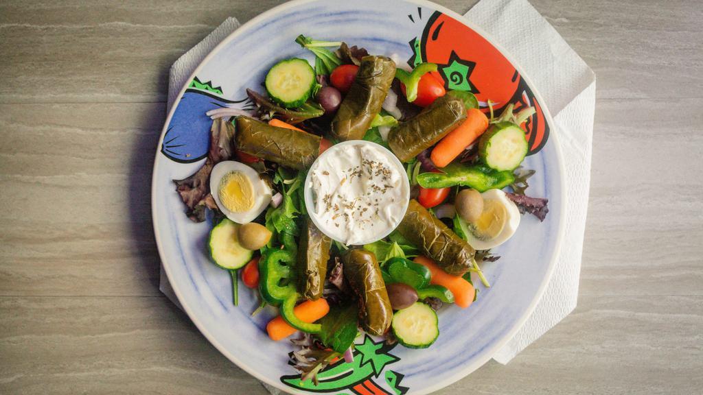Grape Leaves Salad · Salad includes lettuce, tomatoes, onions, green pepper, olives, hard boiled egg, and cucumber. Served with pita bread.