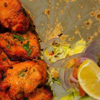 Chicken Tikka Bowl (New) · Marinated chicken cubes grilled & served over a bed of rice, salad & pita on the side