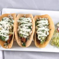 Grilled Chicken Tacos · Gluten-sensitive. Grilled chicken with guacamole, queso fresco, onions and cilantro and driz...