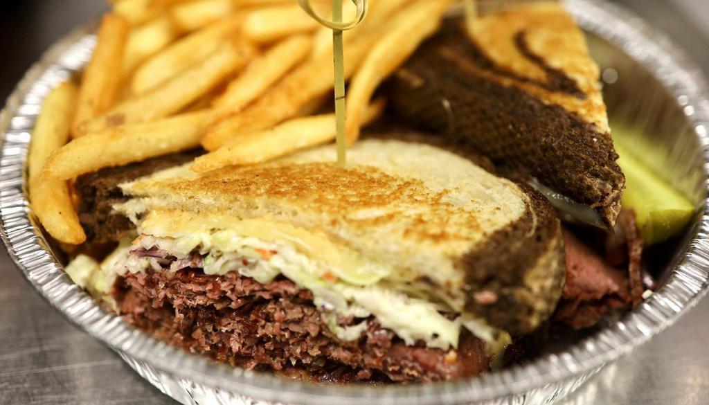 Reuben · Corned beef, Swiss cheese, house-made Napa slaw and Thousand Island Dressing on toasted marble rye bread