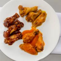 Buffalo Style Bone In Chicken Wings · Served with celery sticks and blue cheese dressing and your choice of Mr. Wing sauce.