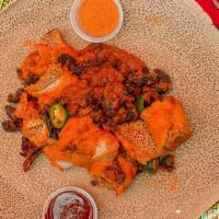 Tibs Firfir · Strips of rolled injera mixed with cubed sautéed beef, onion and jalapeño, seasoned with her...