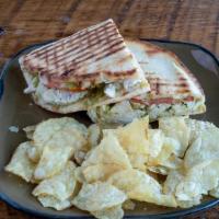 Pesto Chicken Panini · Grilled chicken, pesto, sliced tomatoes, pickled onions, spinach, and melted mozzarella on g...