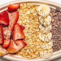 Muesli Overnight Oats · House overnight oats topped with strawberries, bananas, granola, cocoa nibs, and chia seeds