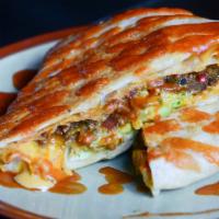 El Cruncho Supremo · Dallas spicy beef, chili con queso, longhorn cheese, avocado crema, lettuce, tomato, tostada...