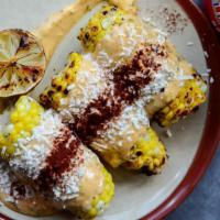 Grilled Street Corn · 3 half ears of corn on the cob, grilled and topped with a cotija + garlic-lime aioli.