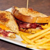 Grilled Reuben · Corned beef, sauerkraut, Russian dressing, and melted Swiss on grilled rye. Served with fries.