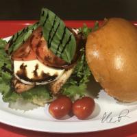 Caprese Chicken · Herb grilled chicken on a bed of lettuce with sliced, vine-ripened tomatoes, fresh mozzarell...