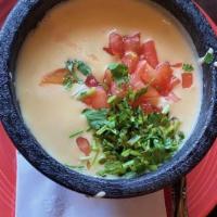 Queso Dip · A blend of creamy cheeses melted dip and roasted green chilies, garnished with cilantro and ...