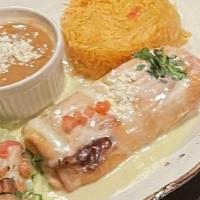 Chimichanga Deluxe · Chicken or Beef. Topped with queso dip, Served with lettuce, sour cream, guacamole, tomato, ...