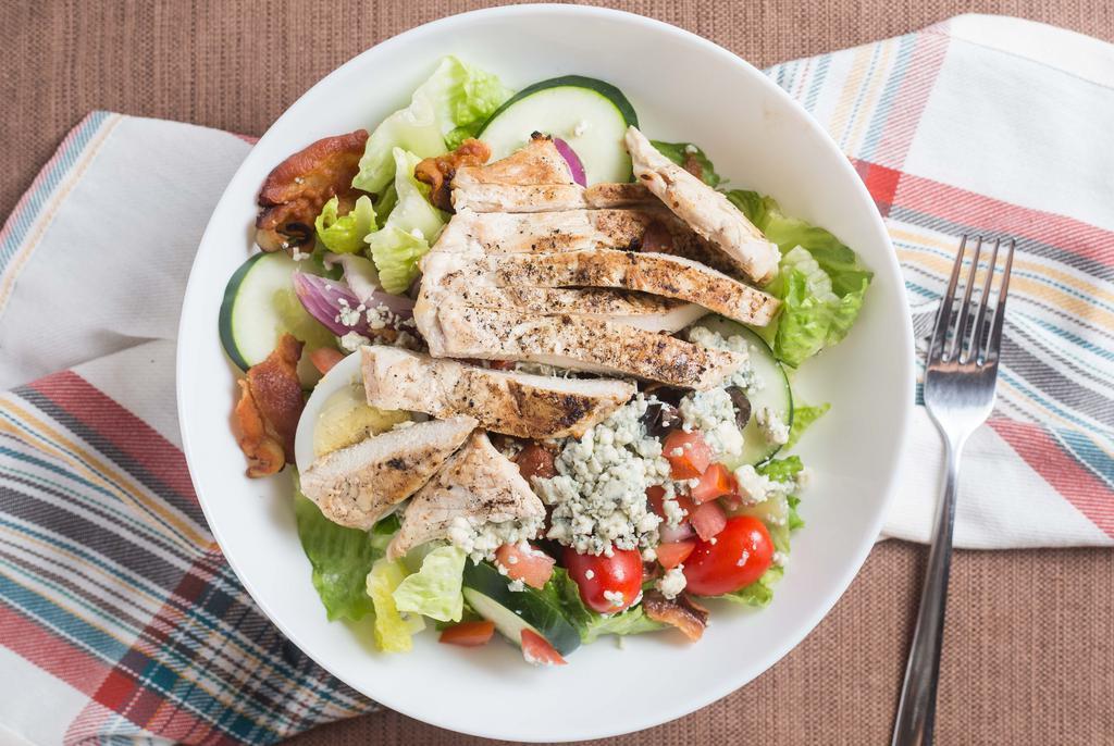 Cobb Salad · Grilled chicken, grape tomatoes, black olives, hard boiled egg, bacon, cheddar, crumbled blue cheese, avocado, over mixed greens, blue cheese dressing.