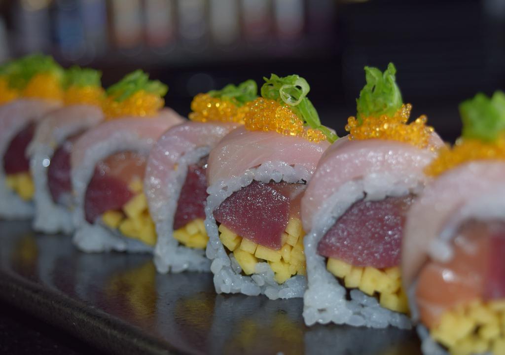 Bruins Maki (8) · Inside tuna, salmon, mango, outside yellowtail, tobiko, scallion, yuzu sauce.