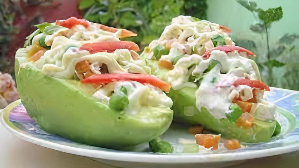 Palta A La Reina · Vegetarian. Gluten-free. Half of an avocado topped with peruvian chicken salad.
