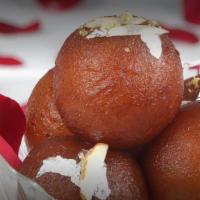 Shahi Gulab Jamun · Fried balls of dough infused with aromatic syrup topped with cardamom, saffron, dryfruit.