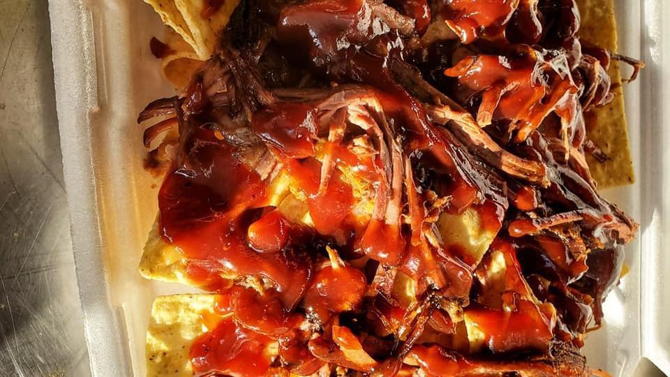 D'S Nachos · with pulled pork and cheese sauce.