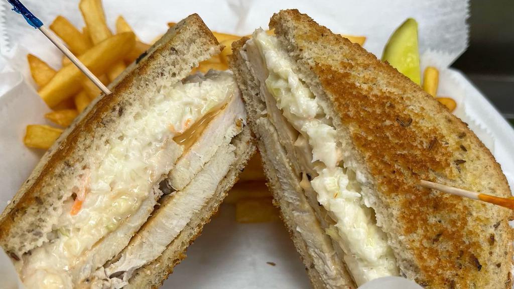 The Rachel · Oven roasted turkey breast, swiss cheese, thousand island dressing, topped with our amazing slaw on Rye bread. 
Can be served on grilled rye with melted swiss 
or on soft rye with unmelted swiss.