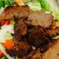 Gyro Salad · Our popular gyro meat served on a bed of lettuce, tomato, cucumbers, and onion, served with ...