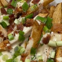 Loaded Fries · Our boardwalk fries were loaded with white cheddar cheese sauce and bacon with a side of sou...