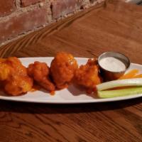 Buffalo Cauliflower · Tossed in our house made buffalo sauce, with blue cheese crumble