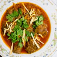 Lamb Curry · Slow-cooked lamb curry served on a bed of basmati rice,  Freshly baked bread with your choic...