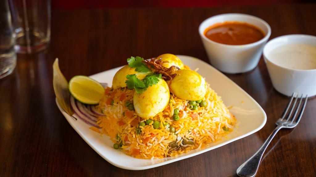Egg Biryani · An Indian dish made to be thoroughly enjoyed by anyone who eats it. Made with the best basmati rice and a perfect blend of spices. Egg pieces are fried separately and then layered with dum cooked biryani.