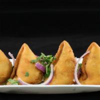 Samosas · Fried pastry with a savory filling of spiced potatoes and green peas. A pocket bursting with...