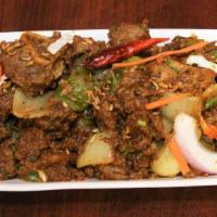 Goat Sukka · Goat marinated in medley of spices and cooked till dry. Garnished with curry leaves.
