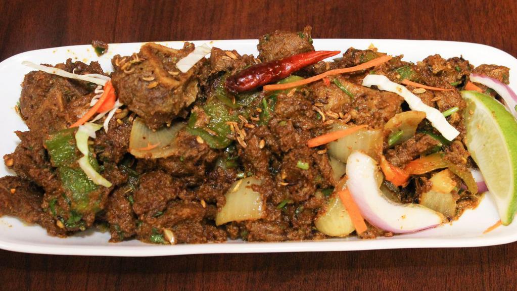 Goat Sukka · Goat marinated in medley of spices and cooked till dry. Garnished with curry leaves.