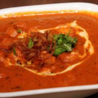 Chicken Butter Masala · Marinated chicken cooked in a mild curry base featuring butter.