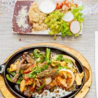 Mexican Fajitas · Comes with beef, chicken, and shrimp. Served with rice, beans, salad, sour cream, pico de ga...