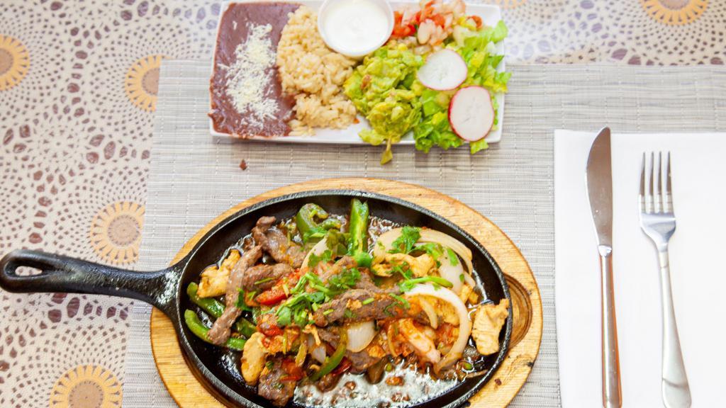Mexican Fajitas · Comes with beef, chicken, and shrimp. Served with rice, beans, salad, sour cream, pico de gallo, guacamole, and flour or corn tortillas.