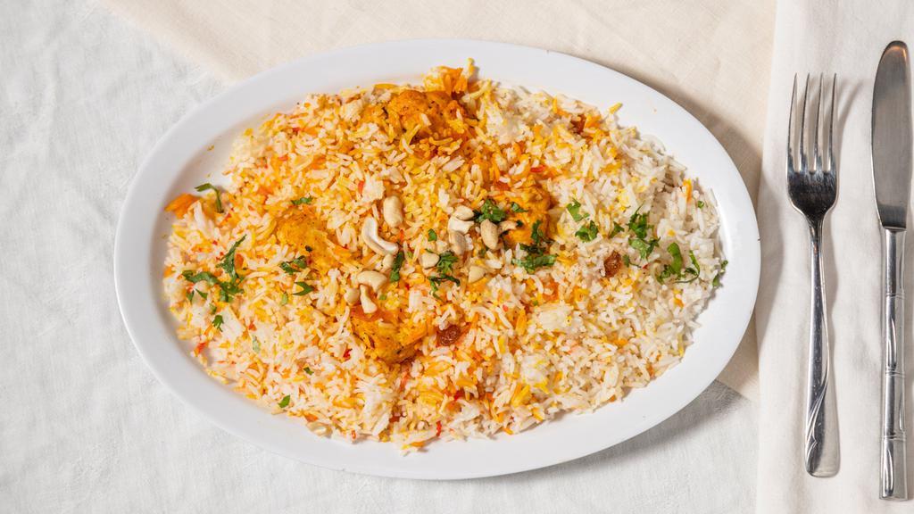 Chicken Biryani · Tender pieces of juicy chicken prepared with basmati rice, flavored with saffron and delicate spices.