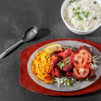 Tandoori Chicken · Spring chicken marinated overnight in yogurt flavored with fresh aromatic Indian spices and ...