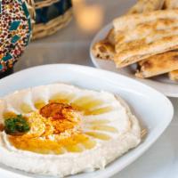 Hummus · Steamed chickpeas blended with tahini, lemon and herbs, served with Afghan bread.