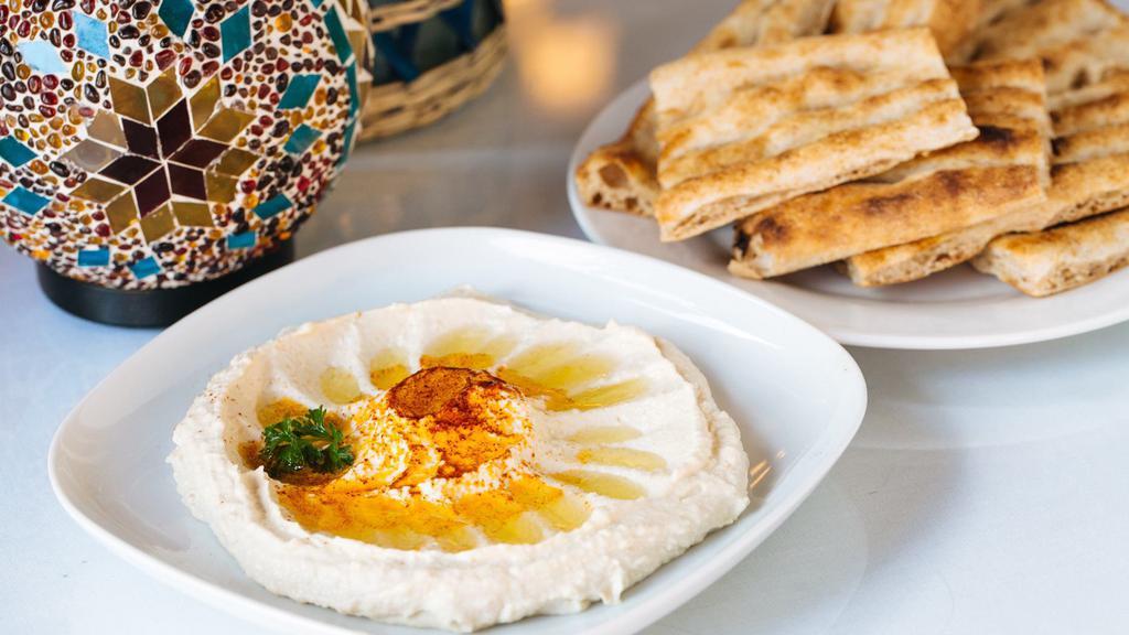 Hummus · Steamed chickpeas blended with tahini, lemon and herbs, served with Afghan bread.