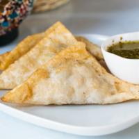 Sambosa · Fried pastries filled with chickpeas and potatoes, served with cilantro chutney.