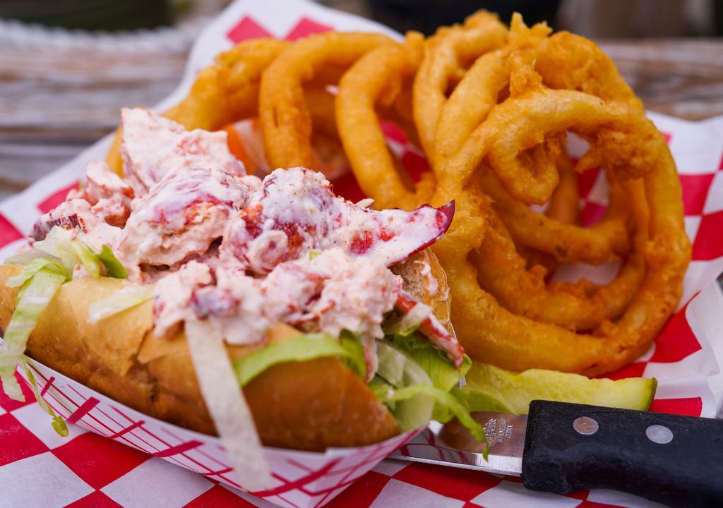 1/2 Lb Lobster Roll  · A heaping ½ lb and sub made of lightly seasoned meat tossed in celery and mayonnaise over lettuce with slaw on the side. Served with French fries and a pickle.