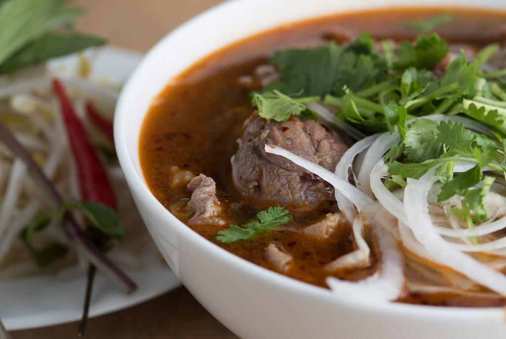Bún Bò Huế · Spicy. Hue city soup. Spicy beef lemongrass with large vermicelli soup. Choose slices eye round or slice shank (hard meat).