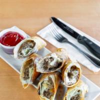Cheesesteak Spring Rolls · Homemade crispy egg roll filled with chipped steak, and melted american cheese served with a...