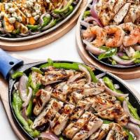 Sizzling Fajitas - Pick 2 · Your choice of 2 proteins: No antibiotic ever chicken, carnitas, and/or grilled shrimp, gree...