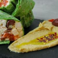 Mediterranean Chicken Wrap · Chicken breast, cucumber, tomato, Kalamata olives, feta, and hummus on a spinach wrap.