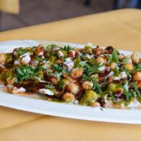 Papri Chaat · Crispy wafers topped with chickpeas, potatoes yogurt tamarind and mint chutney and sprinkled...