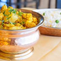 Gobhi Aloo · An ensemble of cauliflower and baby potatoes cooked in blend of spices. Served with saffron ...