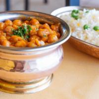 Chana Punjabi · Chickpeas gently cooked with onions, herbs and tomatoes. Served with saffron basmati rice an...