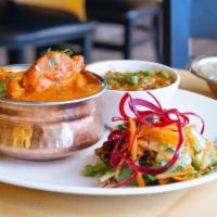 Chicken Tikka Masala · Tandoori chicken tenders cooked in a delightful delicate and tangy tomato sauce. Served with...