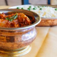 Murg Vindaloo · A spicy chicken and curry with a touch of vinegar and potatoes. Served with saffron basmati ...