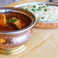 Lamb Vindaloo · A spicy lamb curry with vinegar and potatoes. Served with saffron basmati rice and mango chu...