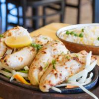 Malai Tikka · Chicken tenders marinated with sour cream and spices baked over a charcoal flame. Served wit...