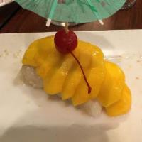Mango Sticky Rice · Sticky rice in coconut syrup topped with golden mango slices.